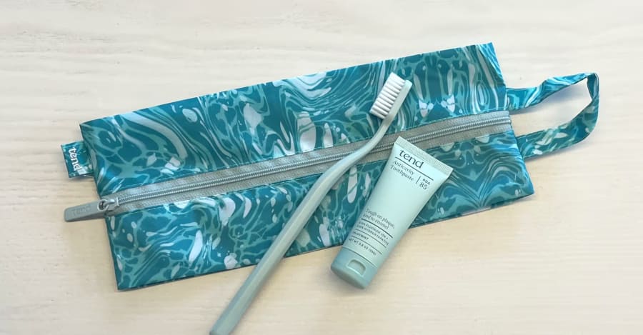 Tend Dental's handly brush bag with a toothbrush and travel sized toothpaste.