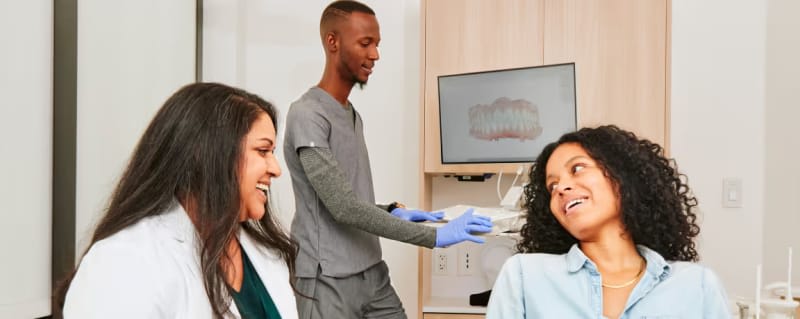 Women in treatment room, chatting happily with two of our team members.