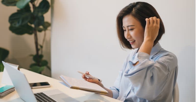 One at a desk writing.